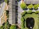 Aerial view of townhomes, with a nearby pond and landscaped grounds at 2296 Whiteoak Se Dr, Smyrna, GA 30080
