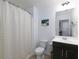 Clean bathroom featuring a shower with curtain, a toilet, and a vanity sink with a cabinet at 2296 Whiteoak Se Dr, Smyrna, GA 30080