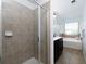 Bathroom showcasing a tiled shower, a soaking tub with a view from the window, and tiled flooring at 2296 Whiteoak Se Dr, Smyrna, GA 30080
