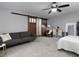 Comfortable bedroom featuring sliding barn doors, a bed, and a seating area at 2296 Whiteoak Se Dr, Smyrna, GA 30080