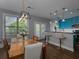 Bright dining area with hardwood floors, bar seating, and a view to the backyard at 2296 Whiteoak Se Dr, Smyrna, GA 30080