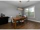 Bright dining room featuring modern lighting, hardwood floors, and a view to the backyard at 2296 Whiteoak Se Dr, Smyrna, GA 30080
