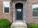 Charming front door with stone archway, brick exterior, and manicured landscaping at 2296 Whiteoak Se Dr, Smyrna, GA 30080