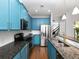 Stylish kitchen with modern appliances, blue cabinets, granite countertops, and hardwood floors at 2296 Whiteoak Se Dr, Smyrna, GA 30080