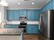 Kitchen features stainless steel appliances, stylish blue cabinets, and subway tile backsplash at 2296 Whiteoak Se Dr, Smyrna, GA 30080