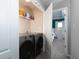Convenient laundry area featuring modern washer and dryer with bedroom view at 2296 Whiteoak Se Dr, Smyrna, GA 30080