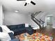 Open living room with hardwood floors, staircase, and large windows providing natural light at 2296 Whiteoak Se Dr, Smyrna, GA 30080