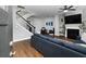 Open-concept living room featuring a fireplace, hardwood floors, and staircase at 2296 Whiteoak Se Dr, Smyrna, GA 30080