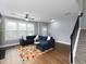 Spacious living room with staircase, sectional sofa, and hardwood floors at 2296 Whiteoak Se Dr, Smyrna, GA 30080