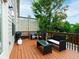 Relax on the outdoor patio with wooden floors, lounge seating, and a grill at 2296 Whiteoak Se Dr, Smyrna, GA 30080
