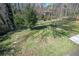 Backyard with a large grassy area, trees, brick pavers and access to concrete patio at 2722 Glenbriar Ne Dr, Atlanta, GA 30345