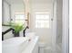 Bright bathroom featuring a double sink vanity with modern black fixtures, toilet and tub at 2722 Glenbriar Ne Dr, Atlanta, GA 30345