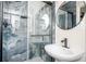 Modern bathroom with rainfall shower behind glass and stylish sink at 2722 Glenbriar Ne Dr, Atlanta, GA 30345