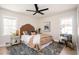 Stylishly furnished bedroom with a patterned rug, modern fan, and warm decor at 2722 Glenbriar Ne Dr, Atlanta, GA 30345