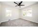 Bright bedroom with two windows, neutral walls, and plush carpeting, plus a modern ceiling fan at 2722 Glenbriar Ne Dr, Atlanta, GA 30345