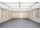 Spacious garage with a white brick wall and built-in shelving along the walls at 2722 Glenbriar Ne Dr, Atlanta, GA 30345
