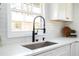 Modern kitchen with a stainless steel sink, spring faucet, white cabinets, and subway tile backsplash at 2722 Glenbriar Ne Dr, Atlanta, GA 30345
