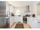 Modern eat-in kitchen with stainless steel appliances, white cabinets, and subway tile backsplash at 2722 Glenbriar Ne Dr, Atlanta, GA 30345
