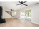 Spacious living room with sliding glass doors to the deck, hardwood flooring, and modern fireplace at 2722 Glenbriar Ne Dr, Atlanta, GA 30345