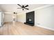 Open-concept living room with hardwood floors, black fireplace accent, recessed lighting, and modern ceiling fans at 2722 Glenbriar Ne Dr, Atlanta, GA 30345