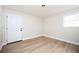 Small room with modern lighting, wood-look flooring, and access door and window at 2722 Glenbriar Ne Dr, Atlanta, GA 30345