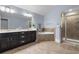Bathroom featuring double vanity sinks, soaking tub, and glass-enclosed shower at 7630 Glisten Ave # 304, Atlanta, GA 30328