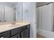 Bathroom featuring a bathtub with shower, a mirror, and vanity with a black cabinet at 7630 Glisten Ave # 304, Atlanta, GA 30328