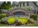 Welcoming brick entrance sign with colorful landscaping for Highlands of Sandy Springs community at 7630 Glisten Ave # 304, Atlanta, GA 30328