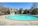 Large community pool with inviting blue water, surrounded by ample seating and mature landscaping at 7630 Glisten Ave # 304, Atlanta, GA 30328