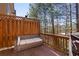 A wooden deck features outdoor seating and a grill, surrounded by trees at 7630 Glisten Ave # 304, Atlanta, GA 30328