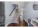 Inviting entryway featuring hardwood floors, staircase with carpet runner, and access to living areas at 7630 Glisten Ave # 304, Atlanta, GA 30328