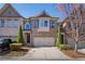 Charming brick townhome featuring an attached two-car garage and beautifully landscaped front yard at 7630 Glisten Ave, Atlanta, GA 30328