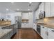 Bright kitchen features white cabinets, stainless steel appliances, granite countertops, and tile backsplash at 7630 Glisten Ave # 304, Atlanta, GA 30328