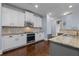 Modern kitchen features white cabinetry, granite countertops, stainless steel appliances, and a tile backsplash at 7630 Glisten Ave # 304, Atlanta, GA 30328