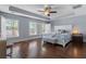 The main bedroom features tray ceilings, three windows, hardwood floors, and a seating bench at 7630 Glisten Ave # 304, Atlanta, GA 30328