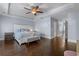 A spacious main bedroom is enhanced by tray ceilings, hardwood floors, and natural light at 7630 Glisten Ave # 304, Atlanta, GA 30328
