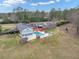 Aerial shot of the property, highlighting the pool, patio, and expansive lawn at 2716 Georgia 16, Carrollton, GA 30116