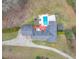 Aerial view of the property showcasing the pool and spacious backyard with a deck at 2716 Georgia 16, Carrollton, GA 30116