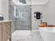 Bathroom featuring a glass shower, freestanding tub, wood cabinet, and marble floors at 2716 Georgia 16, Carrollton, GA 30116