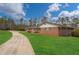 Sprawling brick home with an expansive green lawn and long driveway at 2716 Georgia 16, Carrollton, GA 30116