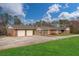 Expansive brick home with an oversized two-car garage, spacious driveway, and well-manicured lawn at 2716 Georgia 16, Carrollton, GA 30116