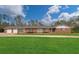 Charming single-story brick home with a lush green lawn and attached two-car garage in a serene setting at 2716 Georgia 16, Carrollton, GA 30116