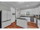 Bright kitchen featuring stainless steel appliances, white cabinets, and dark countertops at 2716 Georgia 16, Carrollton, GA 30116