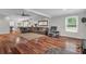 Open-concept living room featuring hardwood floors, a large sectional sofa, and plenty of natural light at 2716 Georgia 16, Carrollton, GA 30116