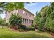 View of the home's backyard with lush lawn, mature trees, and well-maintained landscaping at 2750 Vinings Orchard Se Cir, Atlanta, GA 30339