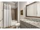 Modern bathroom boasts granite counters, framed mirror, and a shower-tub combination at 2750 Vinings Orchard Se Cir, Atlanta, GA 30339