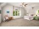 Comfortable bedroom with a window seat, soft lighting, and a ceiling fan at 2750 Vinings Orchard Se Cir, Atlanta, GA 30339