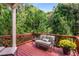 Outdoor deck featuring wood floors, views of the surrounding trees, and a comfortable seating area at 2750 Vinings Orchard Se Cir, Atlanta, GA 30339