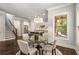 Charming dining area with a glass table, hardwood floors, and a view into the bright kitchen at 2750 Vinings Orchard Se Cir, Atlanta, GA 30339