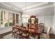 Traditional dining room featuring hardwood floors, wainscoting, and an elegant chandelier over a large dining table at 2750 Vinings Orchard Se Cir, Atlanta, GA 30339